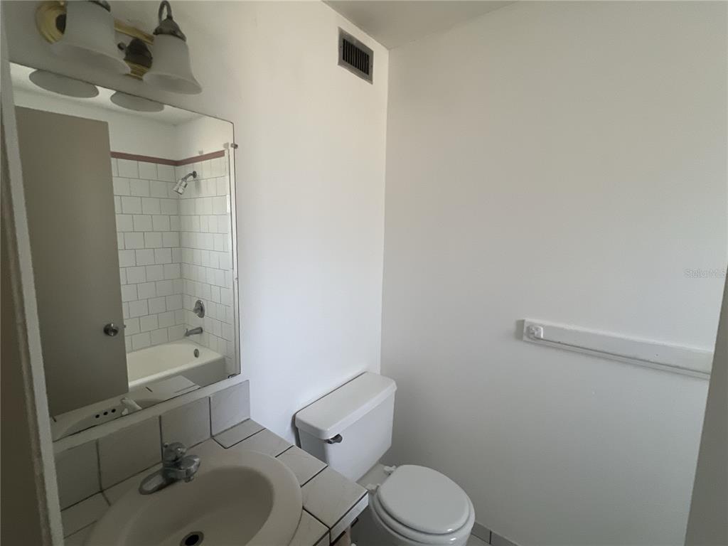 11558 Southeast 58th Avenue Belleview, FL 34420 - Photo 24 of 26 a bathroom with a sink a toilet and shower