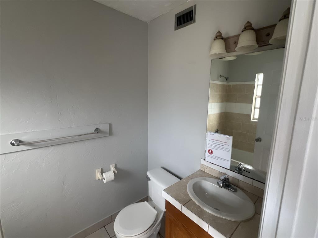 11558 Southeast 58th Avenue Belleview, FL 34420 - Photo 7 of 26 a white toilet sitting next to a bathroom sink
