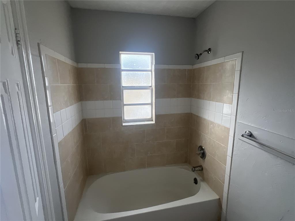 11558 Southeast 58th Avenue Belleview, FL 34420 - Photo 8 of 26 a bath tub sitting in a bathroom next to a window