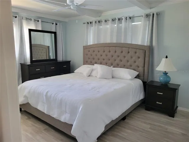 a bedroom with a bed and a mirror