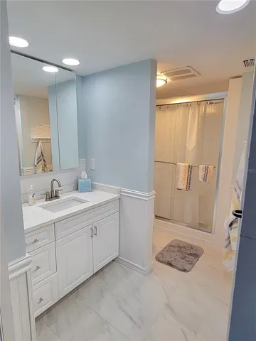 a bathroom with a sink toilet and shower