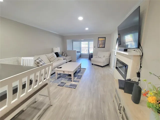 a living room with furniture and fireplace
