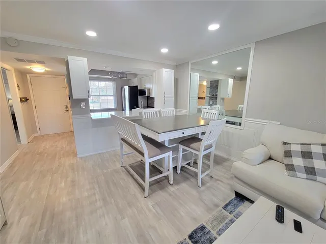 a dining room with furniture and wooden floor