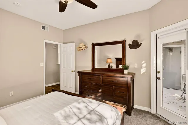 a bedroom with a bed and a mirror on dresser