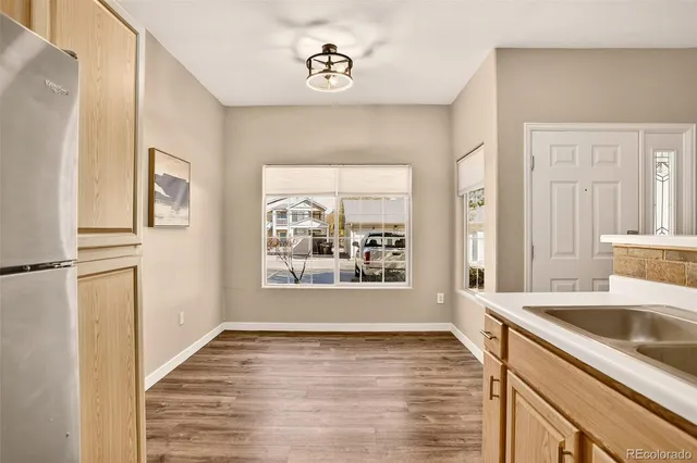 a view of a kitchen cabinets a bed and wooden floor