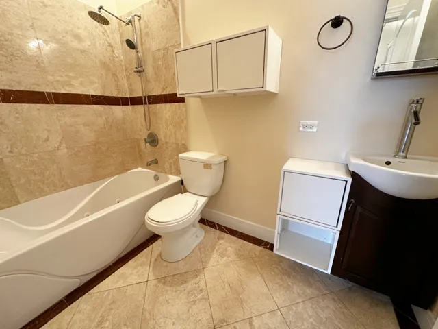 a bathroom with a toilet a sink and bathtub