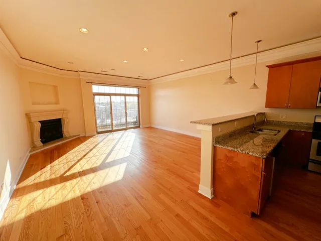 a view of a room with wooden floor and iron fence