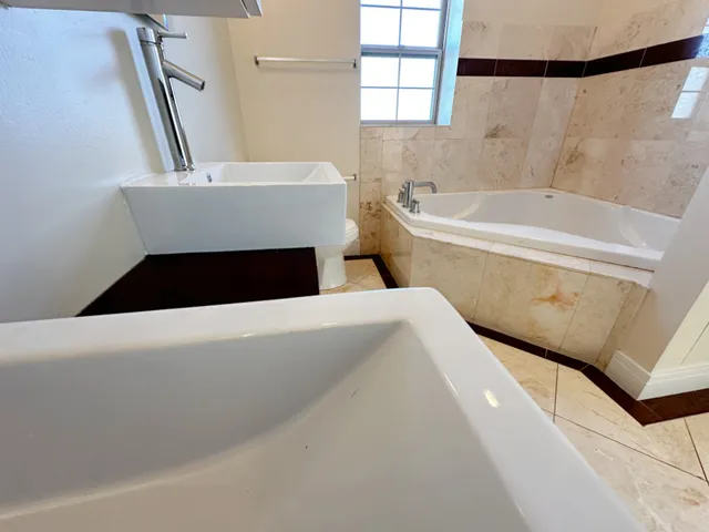 a bathroom with a bathtub and a shower