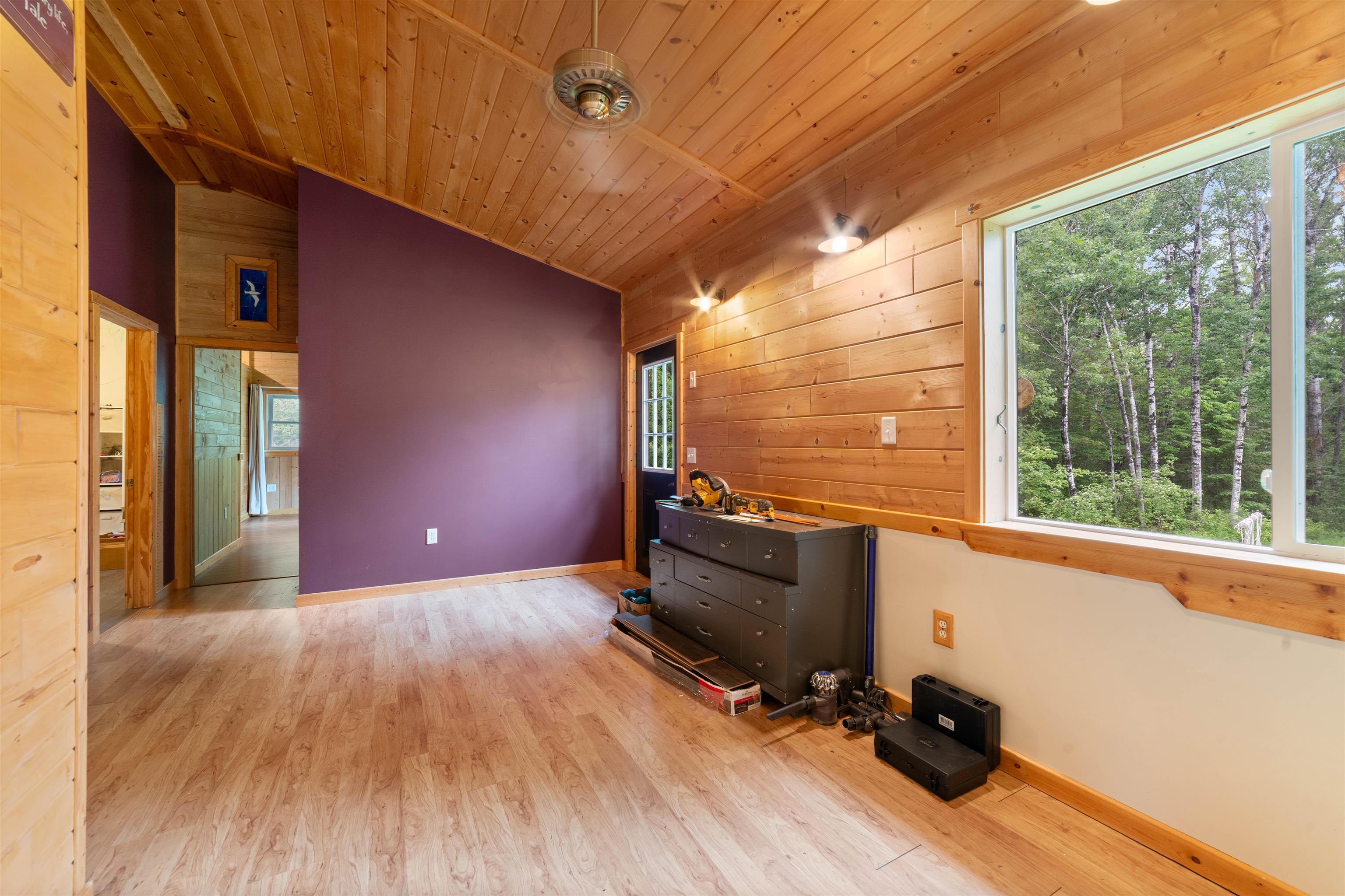 4767 McComber Road Duluth, MN 55803 - Photo 9 of 26 Unfurnished living room with wood walls, vaulted ceiling, wood finished floors, and wooden ceiling