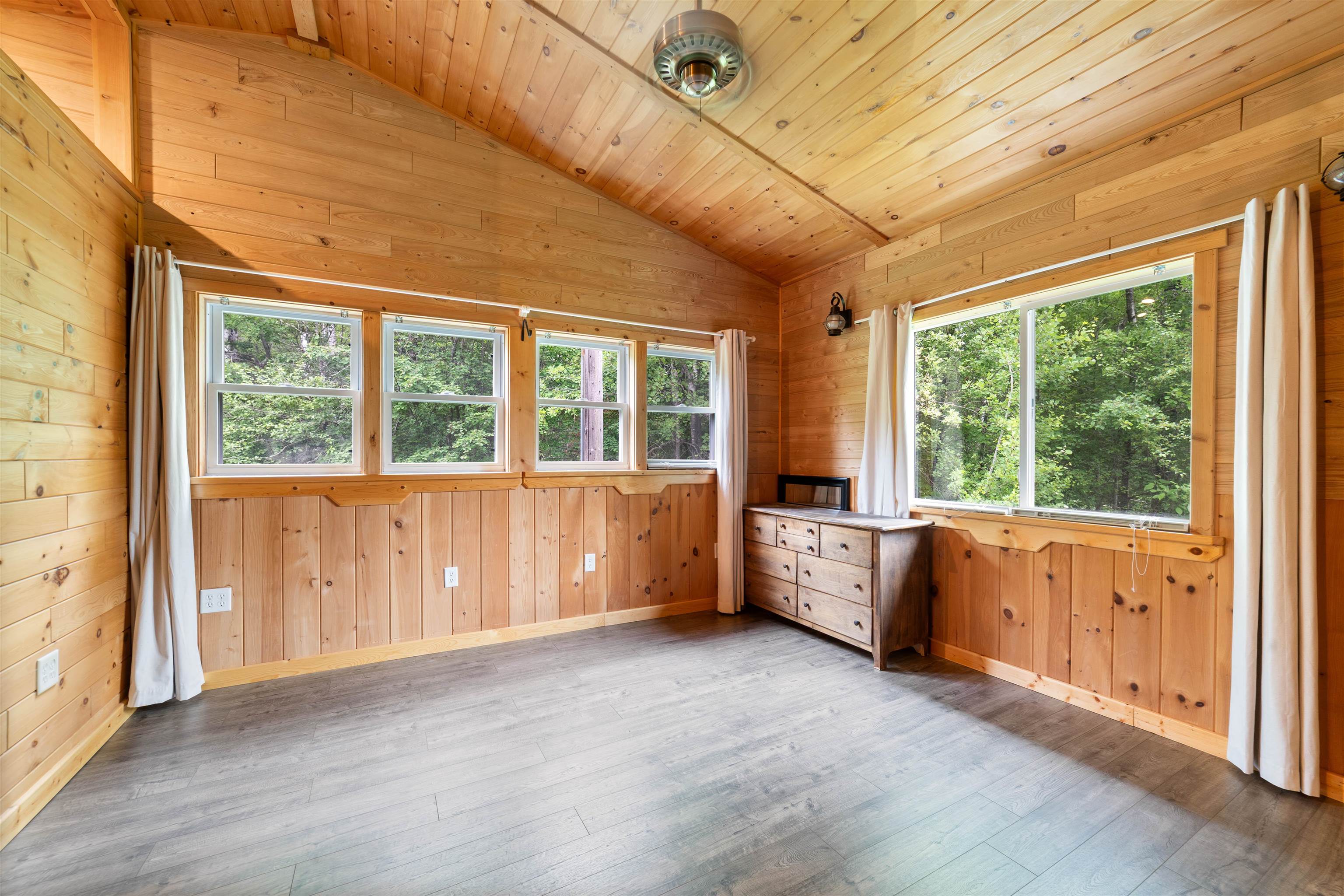 4767 McComber Road Duluth, MN 55803 - Photo 10 of 26 Unfurnished room with vaulted ceiling, wood-type flooring, wooden walls, and wood ceiling