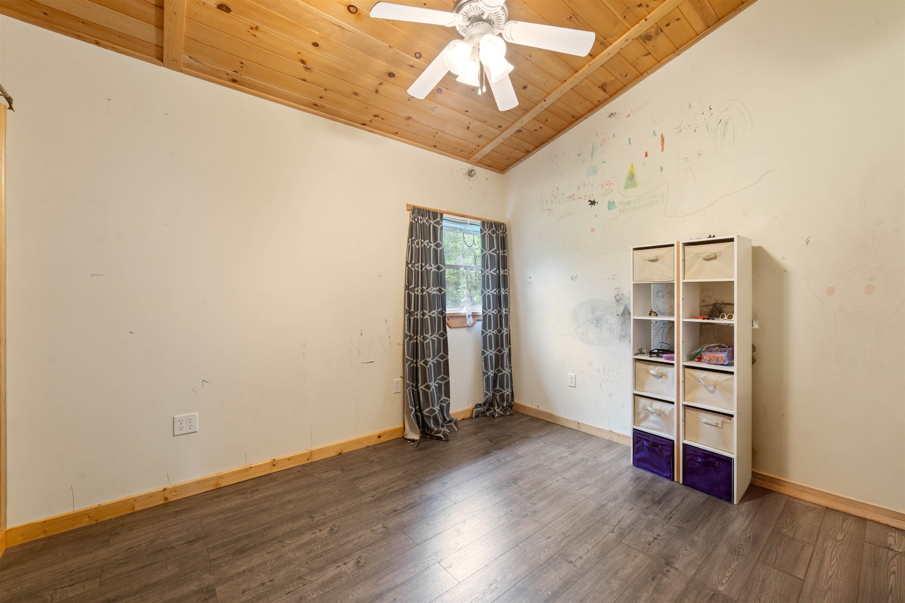 4767 McComber Road Duluth, MN 55803 - Photo 13 of 26 Empty room featuring wood ceiling, wood finished floors, a ceiling fan, and vaulted ceiling