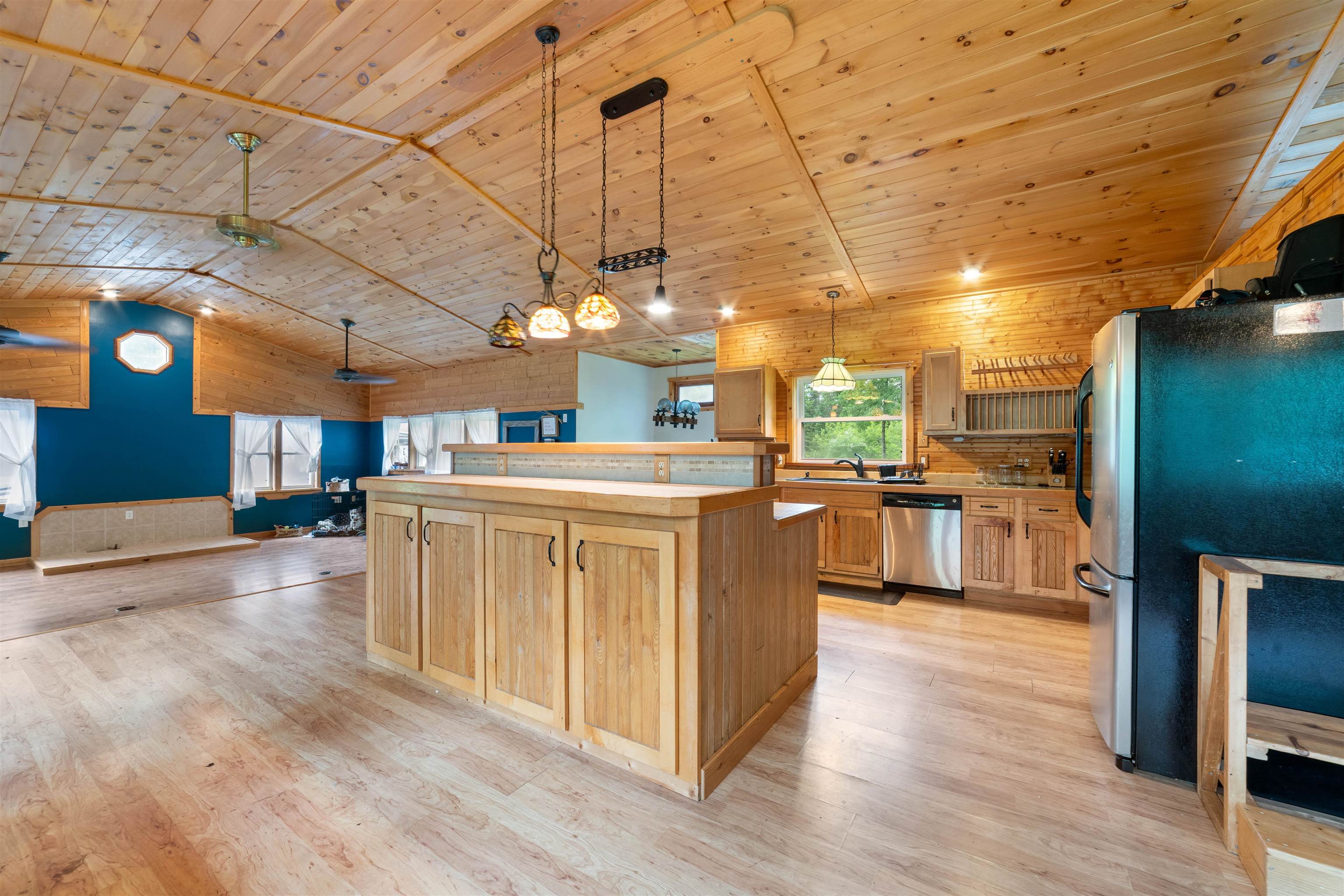 4767 McComber Road Duluth, MN 55803 - Photo 24 of 26 Kitchen with appliances with stainless steel finishes, wood ceiling, open floor plan, light brown cabinetry, and light wood-type flooring