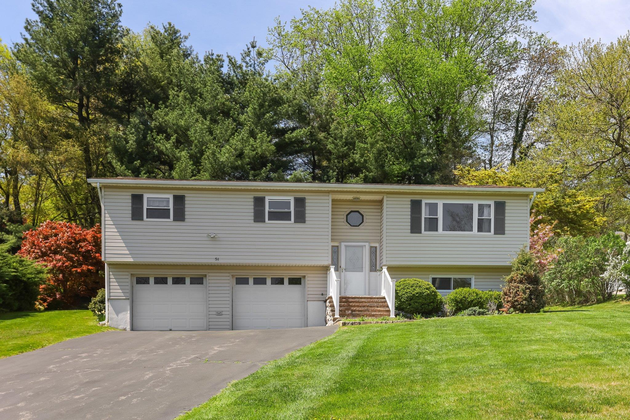 51 Brookside Road Mahopac, NY 10541 - Photo 1 of 1 Split foyer home with entry steps, an attached garage, a front yard, and aphalt driveway