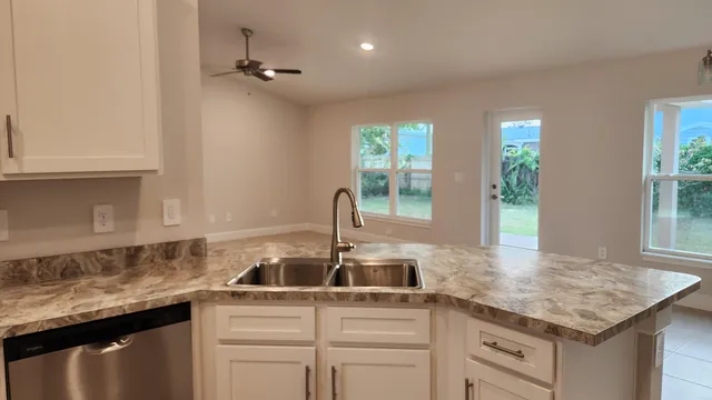 a kitchen with a sink and cabinets