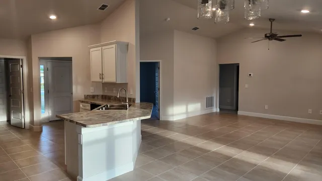 a kitchen with a sink a counter top space and stainless steel appliances