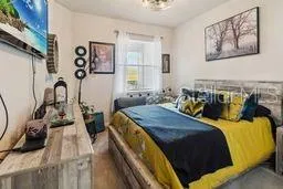 a bed sitting in a bedroom next to a window