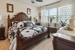 a bedroom with bed and a window