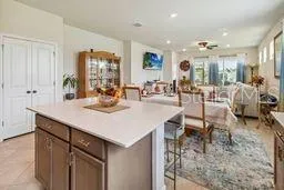 a kitchen with a dining table chairs and white cabinets