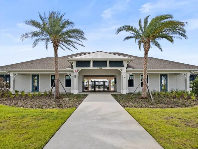 a front view of a house with yard and garage