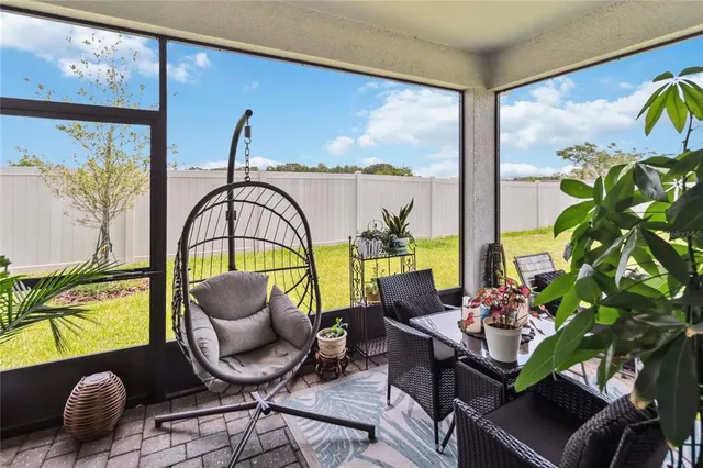 a living room filled with furniture and a potted plant