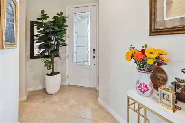 a white vase with white and yellow flowers