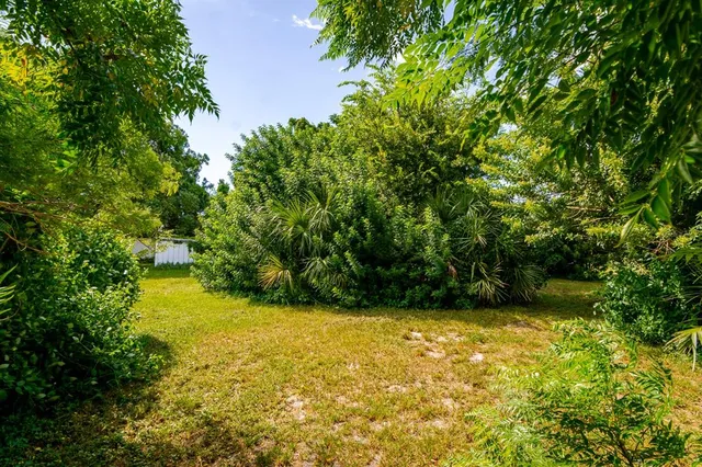 a view of yard with swimming pool and green space