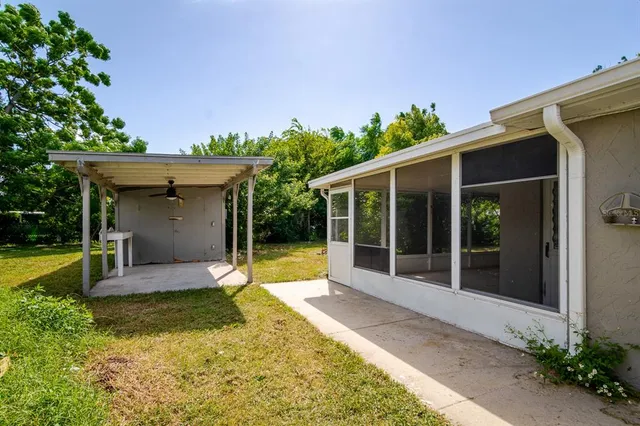 a view of a house with backyard sitting area and garden