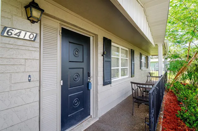 a view of a door and chair in the balcony