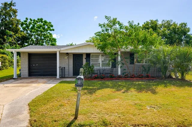a view of a house with swimming pool and a yard