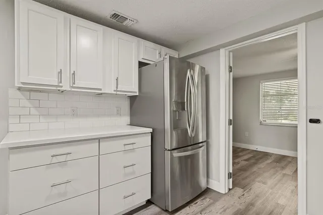 a kitchen with appliances and cabinets