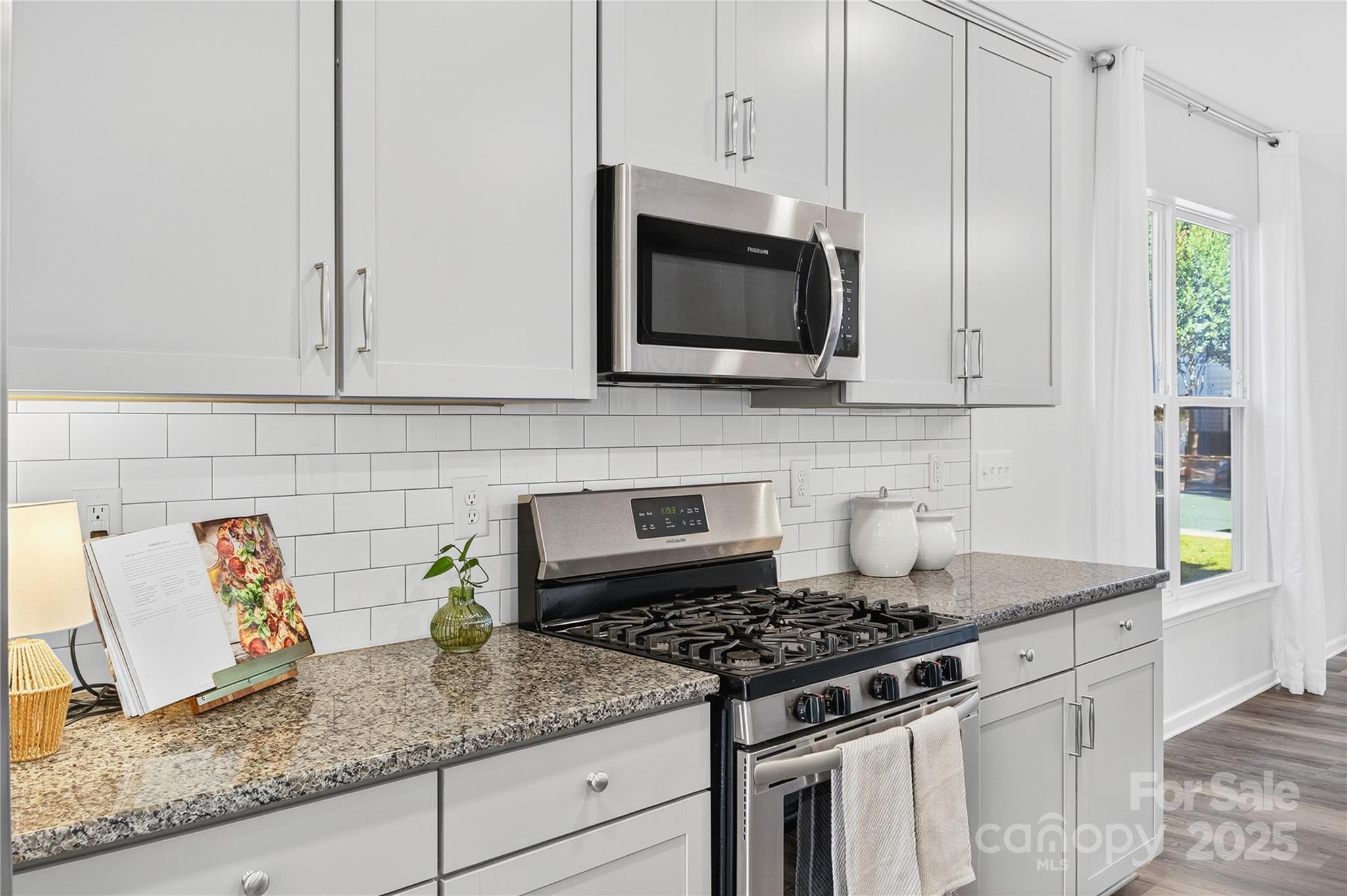 176 Waterlynn Ridge Road Mooresville, NC 28117 - Photo 11 of 25 a kitchen with granite countertop white cabinets and stainless steel appliances