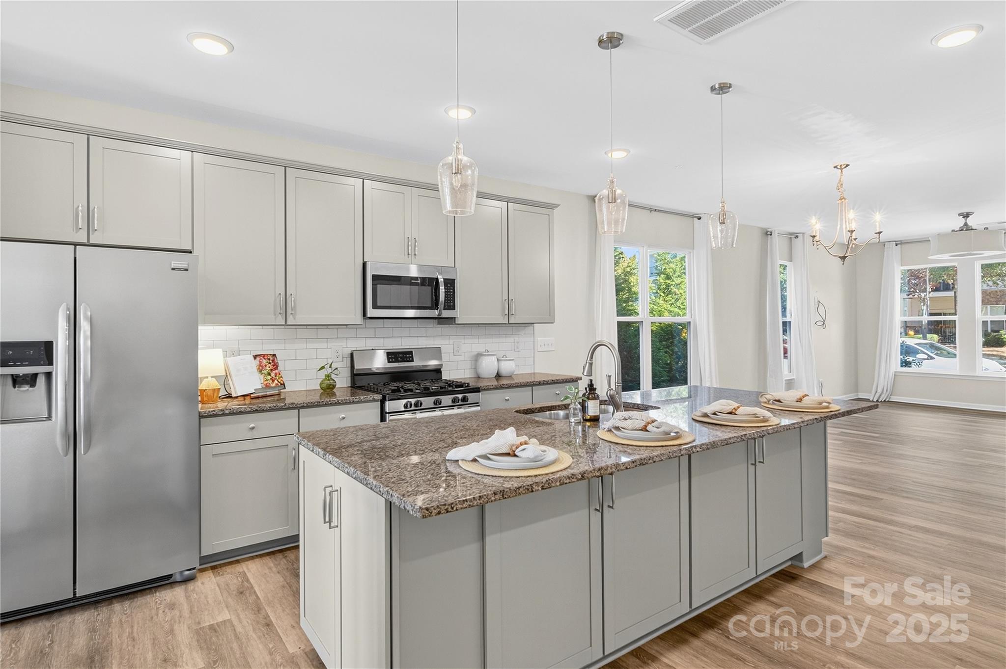 176 Waterlynn Ridge Road Mooresville, NC 28117 - Photo 10 of 25 a kitchen with stainless steel appliances granite countertop a sink a stove a refrigerator a center island and cabinets