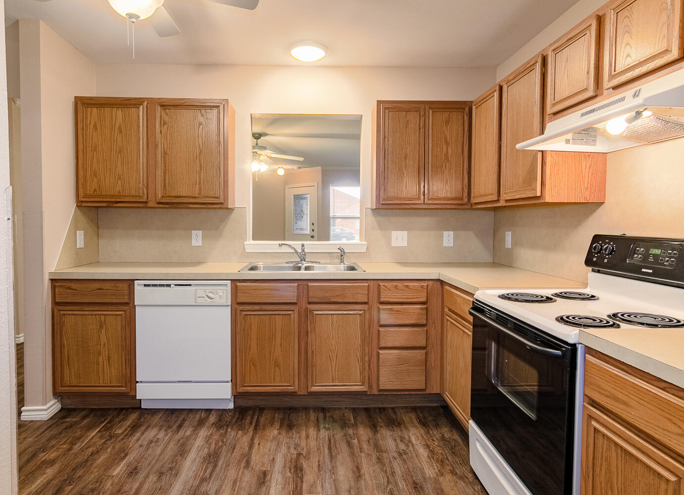 505 North Chicago Avenue, Unit B Lubbock, TX 79416 - Photo 3 of 12 a kitchen with a stove a sink and a refrigerator