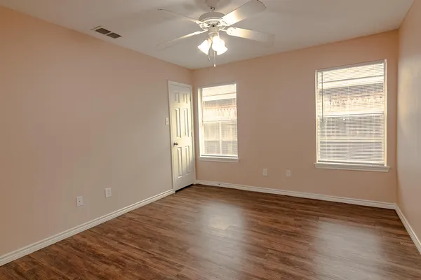 a view of wooden floor and windows in a room
