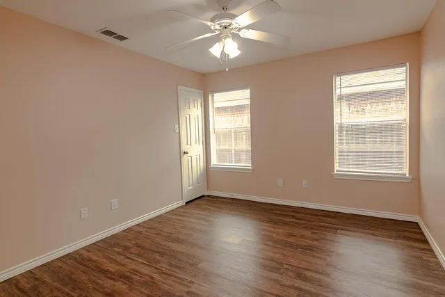 a view of wooden floor and windows in a room