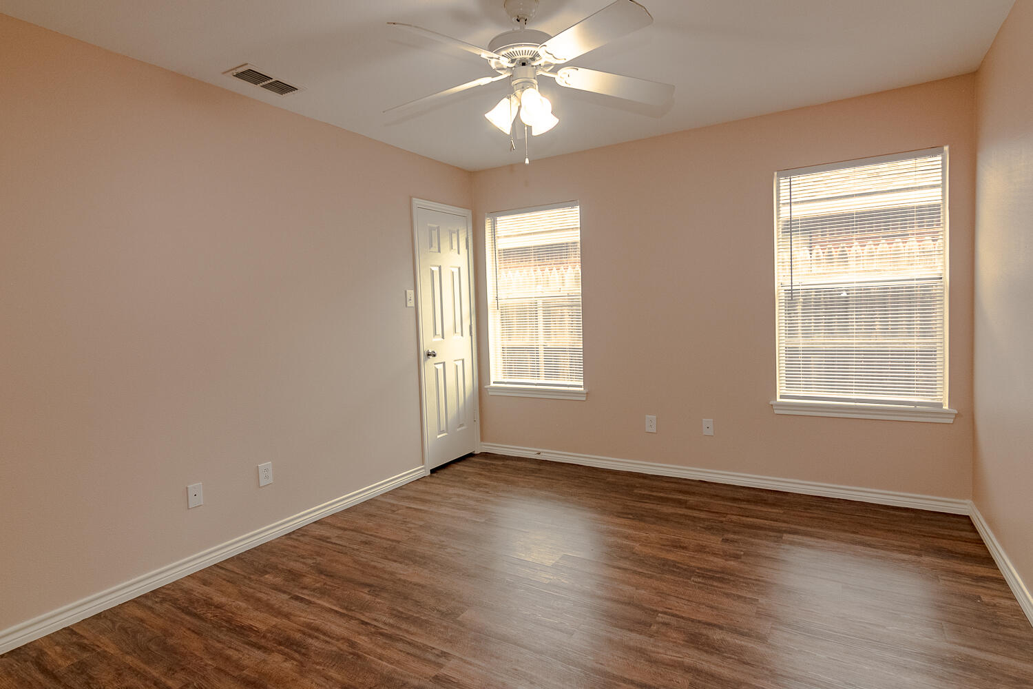 505 North Chicago Avenue, Unit B Lubbock, TX 79416 - Photo 10 of 12 a view of wooden floor and windows in a room