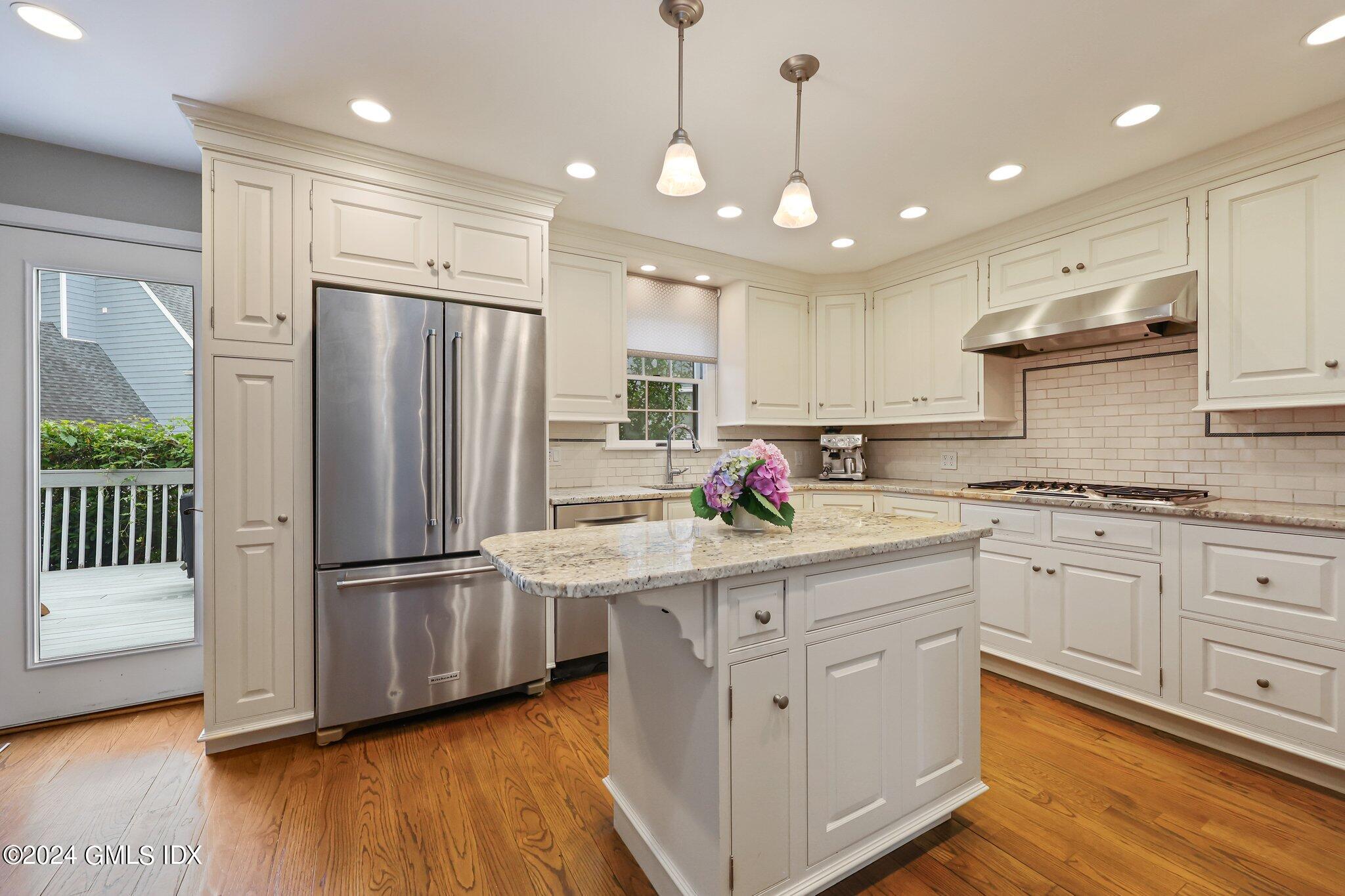 138 Byram Road, Unit 1 Greenwich, CT 06830 - Photo 14 of 36 a kitchen with refrigerator cabinets and wooden floor