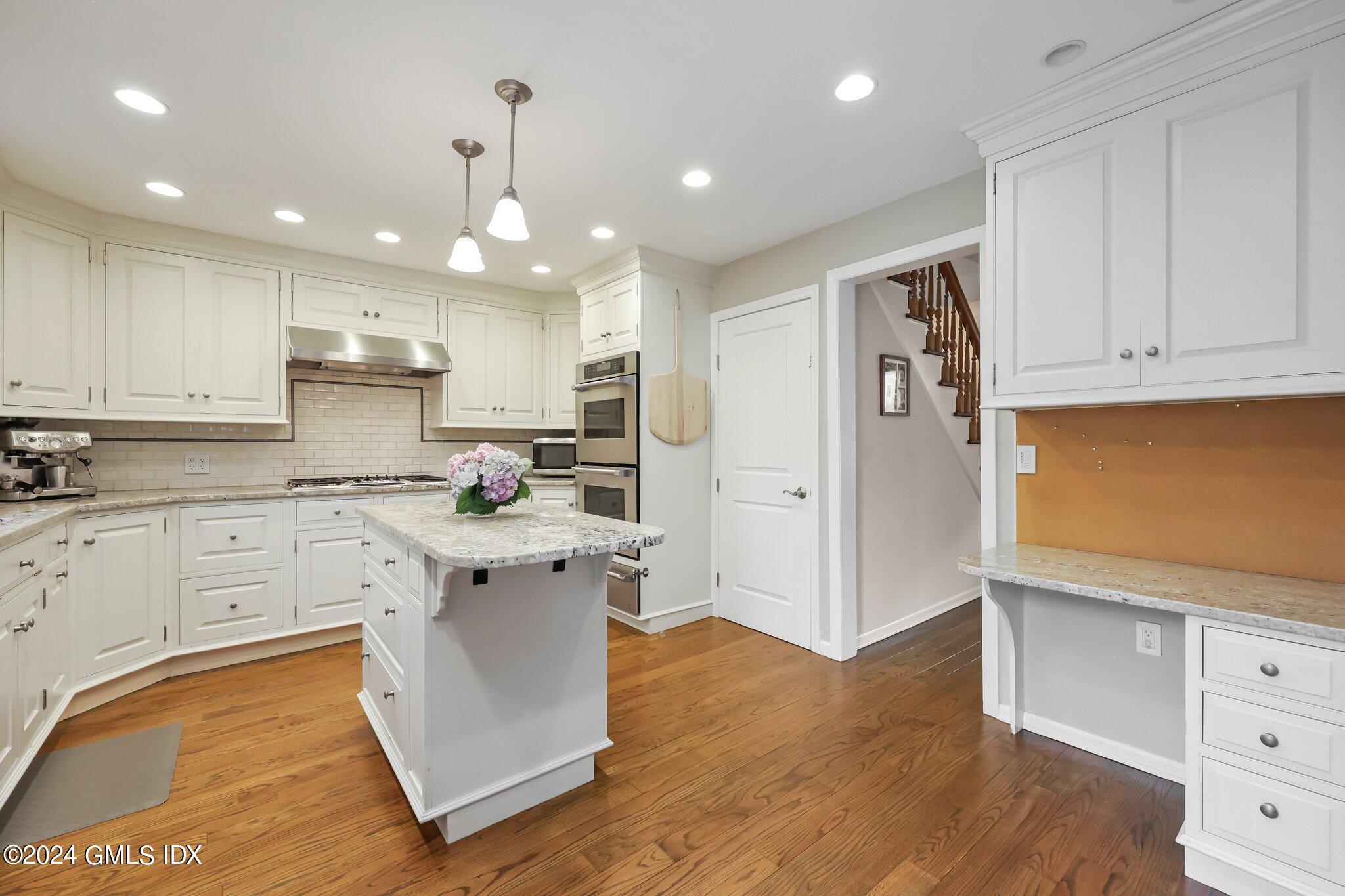 138 Byram Road, Unit 1 Greenwich, CT 06830 - Photo 17 of 36 a kitchen with stainless steel appliances granite countertop a refrigerator sink and white cabinets