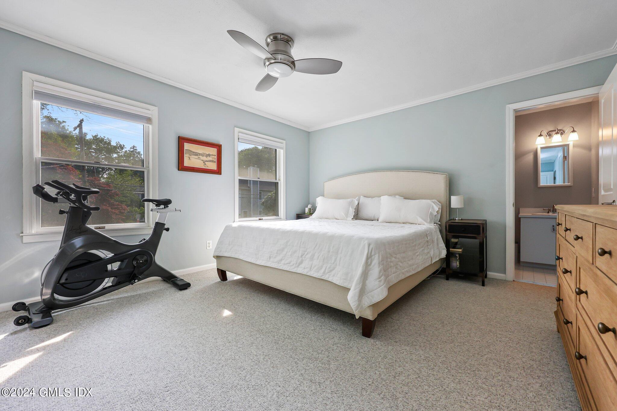 138 Byram Road, Unit 1 Greenwich, CT 06830 - Photo 20 of 36 a bedroom with a bed and a chandelier