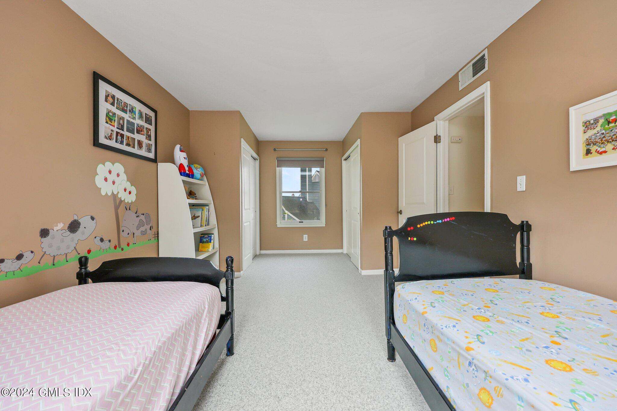 138 Byram Road, Unit 1 Greenwich, CT 06830 - Photo 24 of 36 a bedroom with a bed and a large mirror
