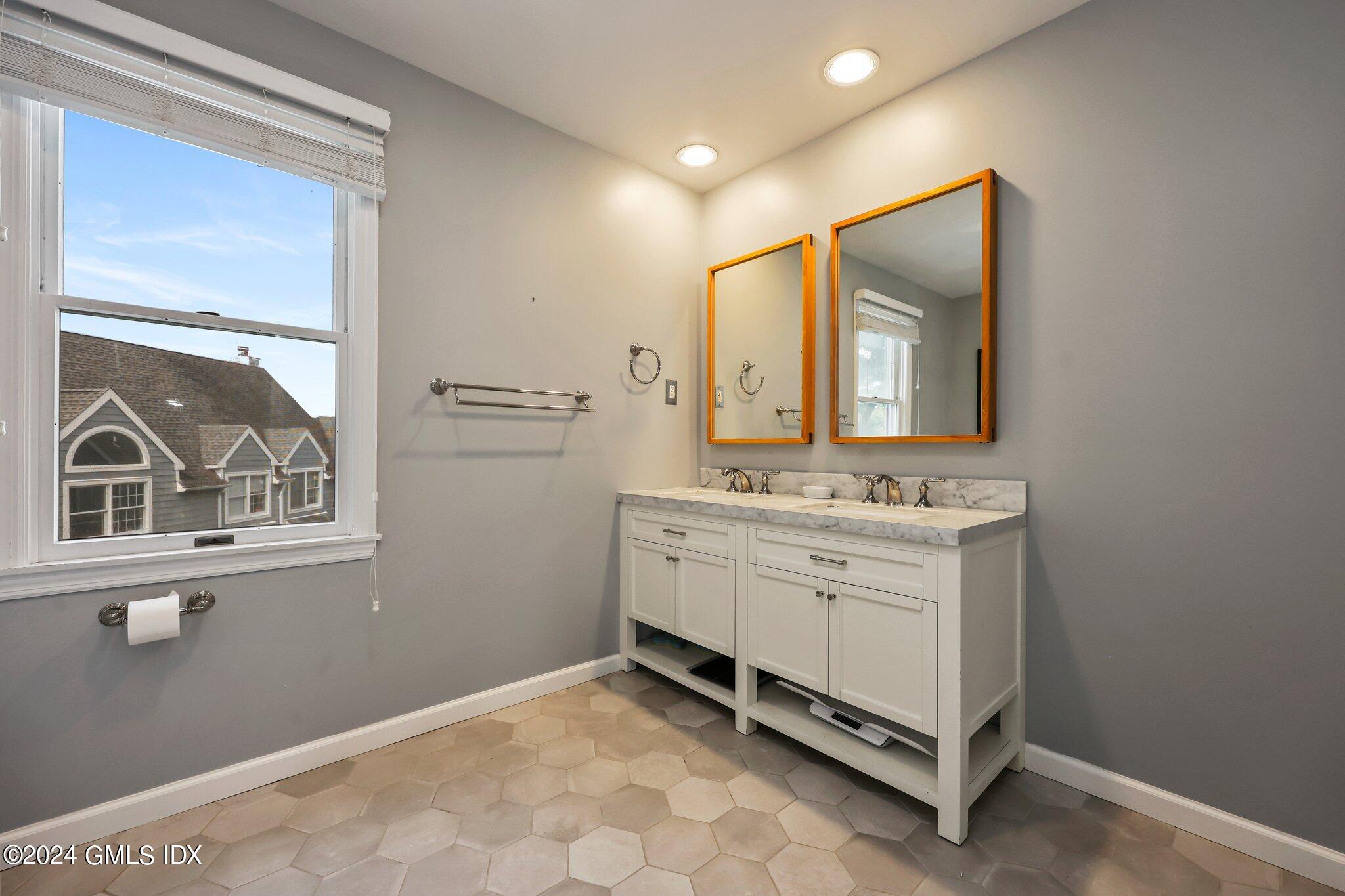 138 Byram Road, Unit 1 Greenwich, CT 06830 - Photo 25 of 36 a bathroom with a sink mirror and a vanity
