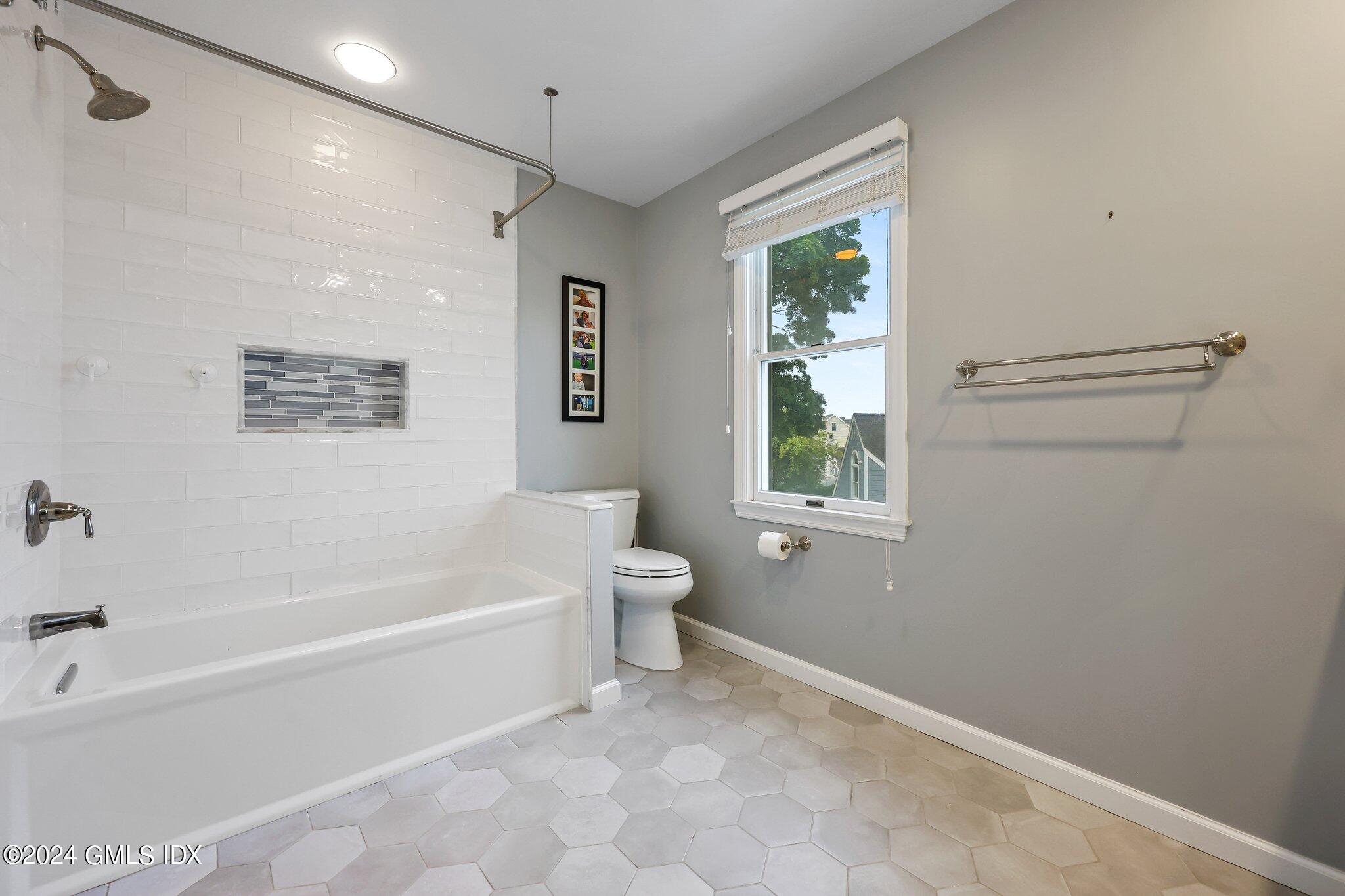 138 Byram Road, Unit 1 Greenwich, CT 06830 - Photo 26 of 36 a white bath tub sitting next to a white toilet