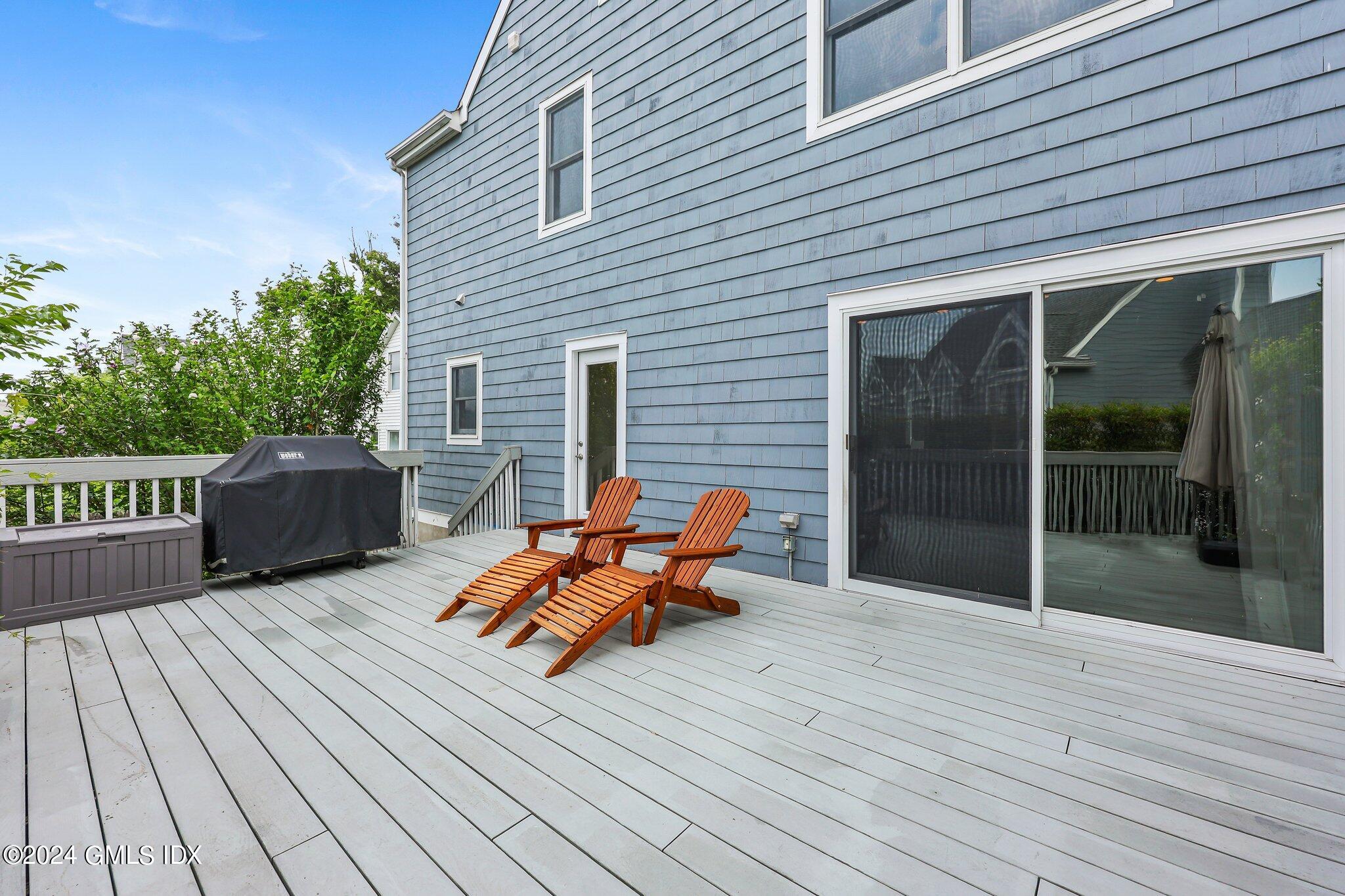 138 Byram Road, Unit 1 Greenwich, CT 06830 - Photo 30 of 36 a backyard of a house with wooden floor and outdoor seating
