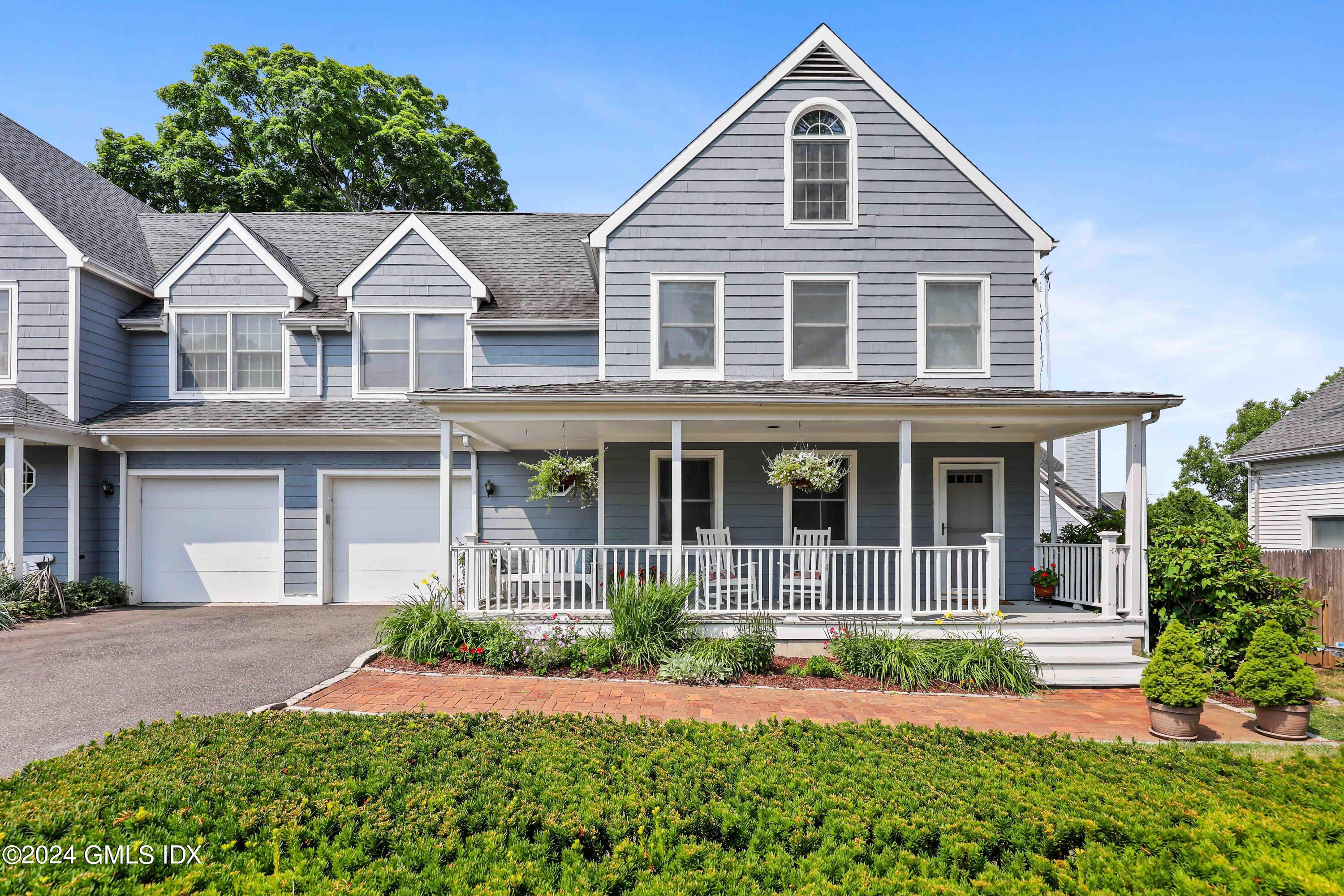 138 Byram Road, Unit 1 Greenwich, CT 06830 - Photo 3 of 36 a front view of a house with a yard