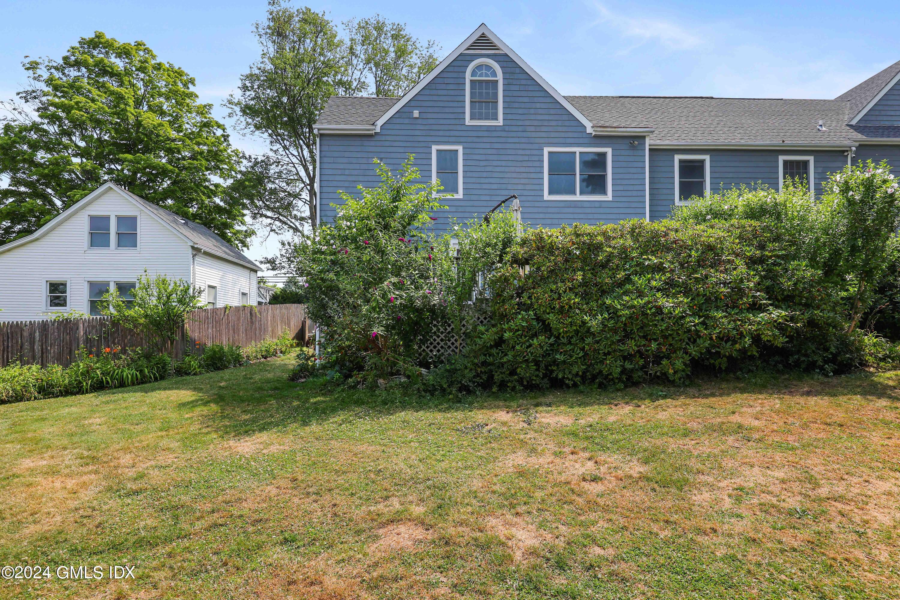 138 Byram Road, Unit 1 Greenwich, CT 06830 - Photo 31 of 36 a front view of a house with garden