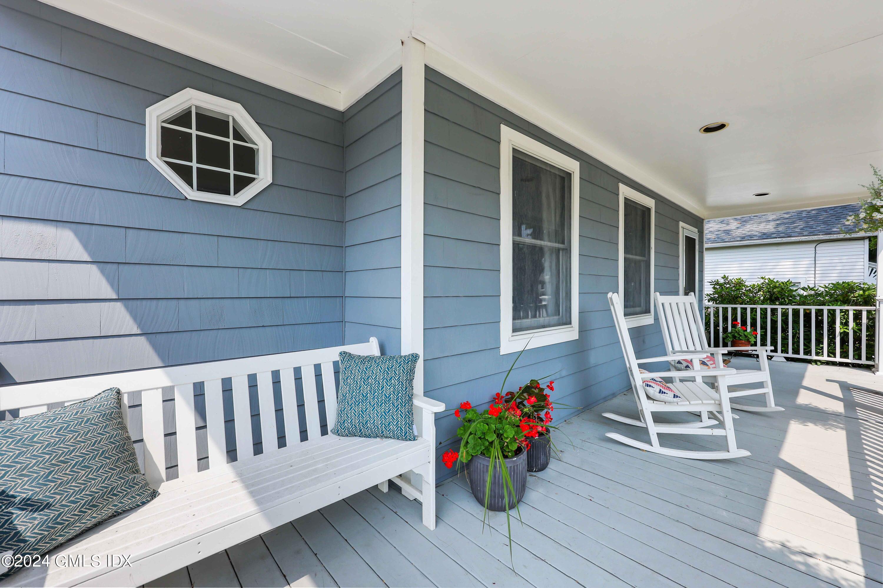 138 Byram Road, Unit 1 Greenwich, CT 06830 - Photo 4 of 36 a balcony with chairs and wooden floor