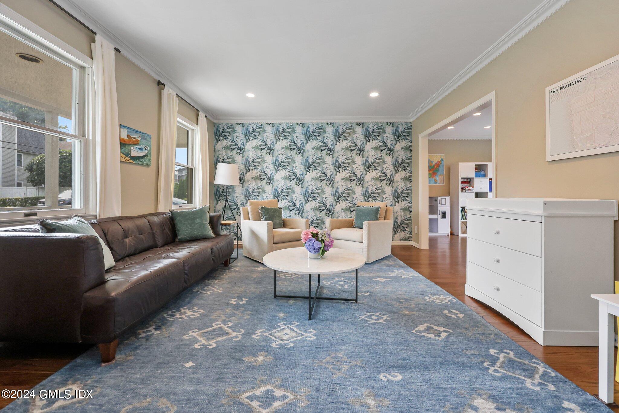 138 Byram Road, Unit 1 Greenwich, CT 06830 - Photo 6 of 36 a living room with furniture a large window and a potted plant