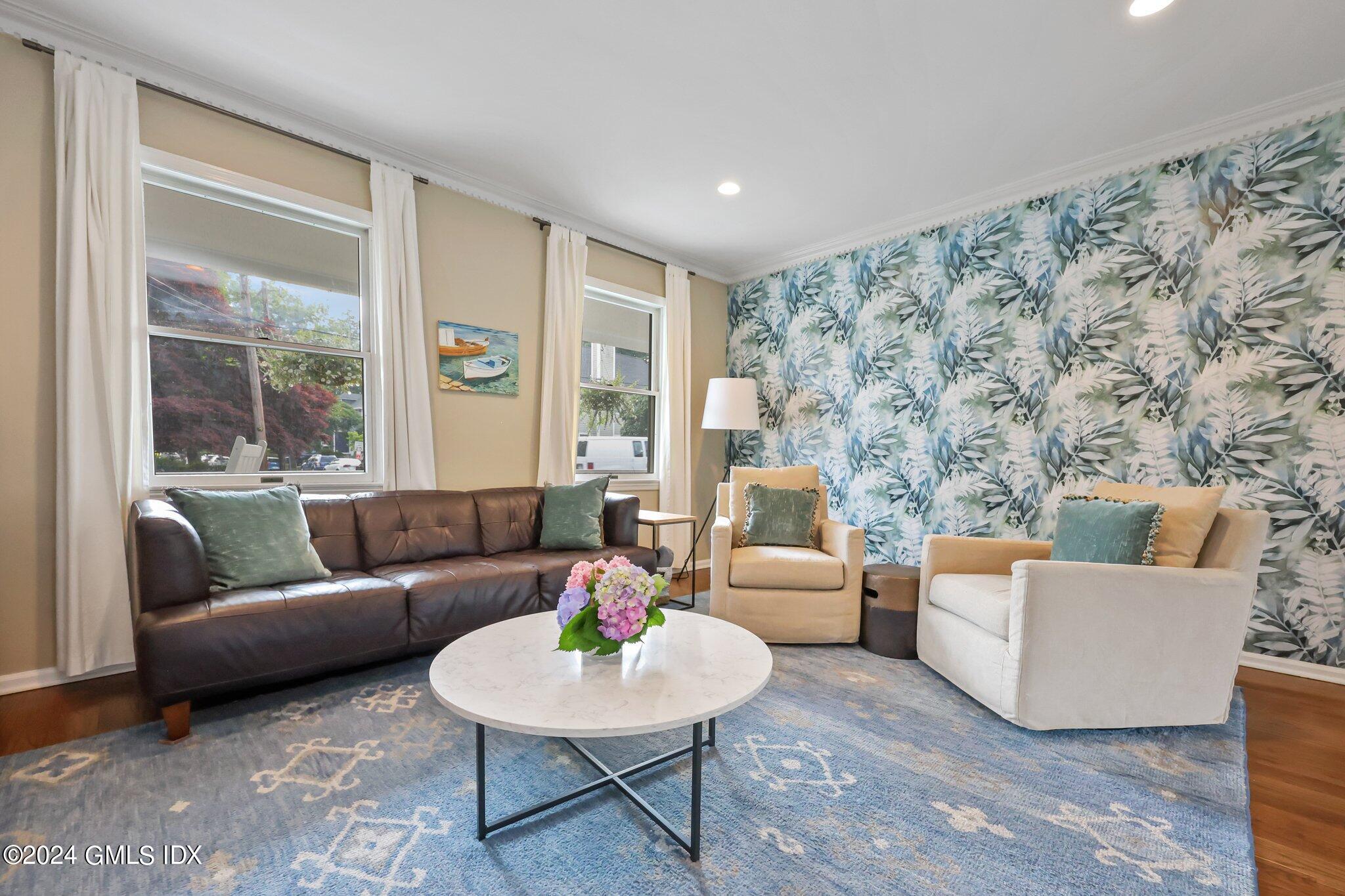 138 Byram Road, Unit 1 Greenwich, CT 06830 - Photo 7 of 36 a living room with furniture and a large window