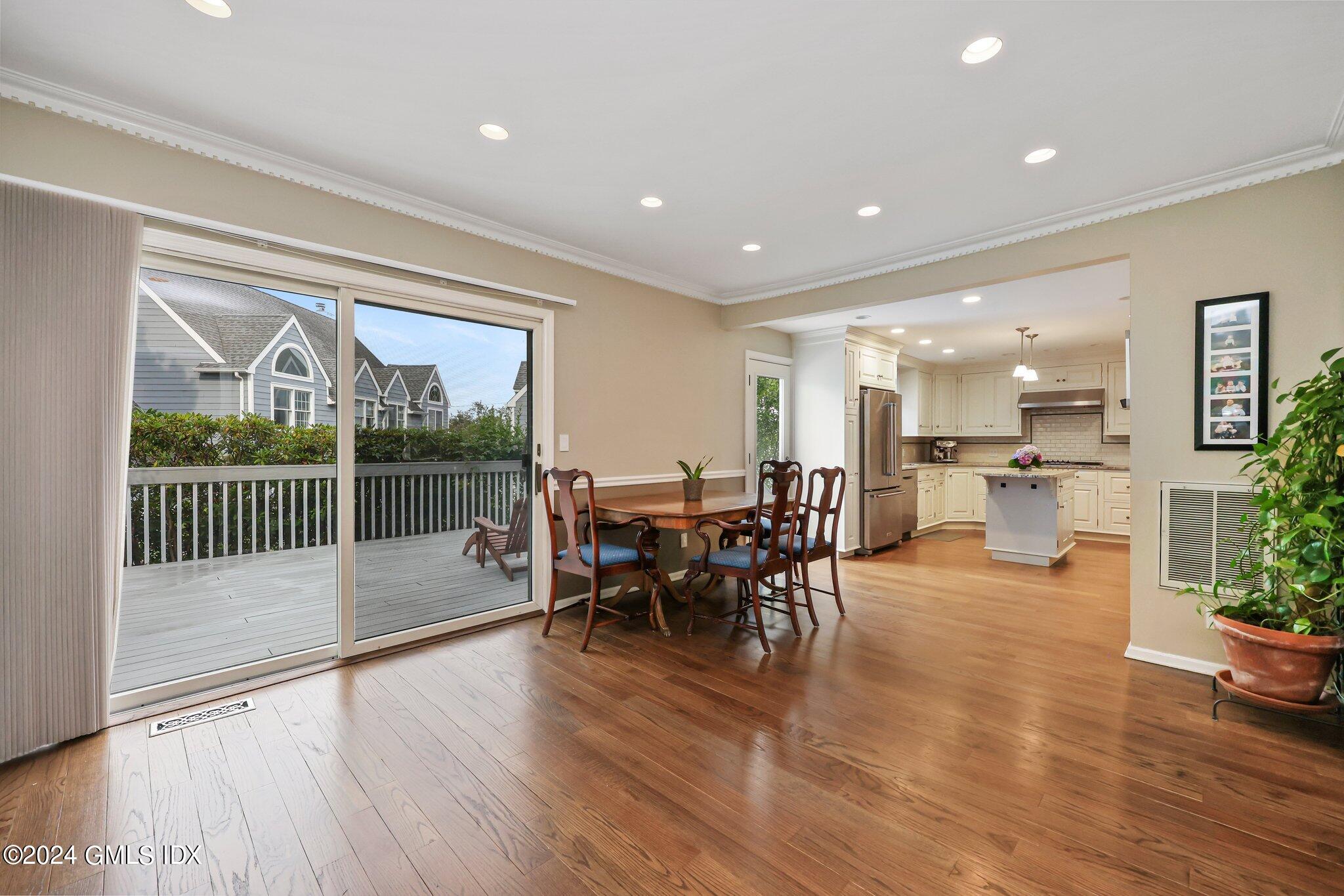 138 Byram Road, Unit 1 Greenwich, CT 06830 - Photo 10 of 36 a view of a dining room and livingroom with furniture wooden floor and a floor to ceiling window