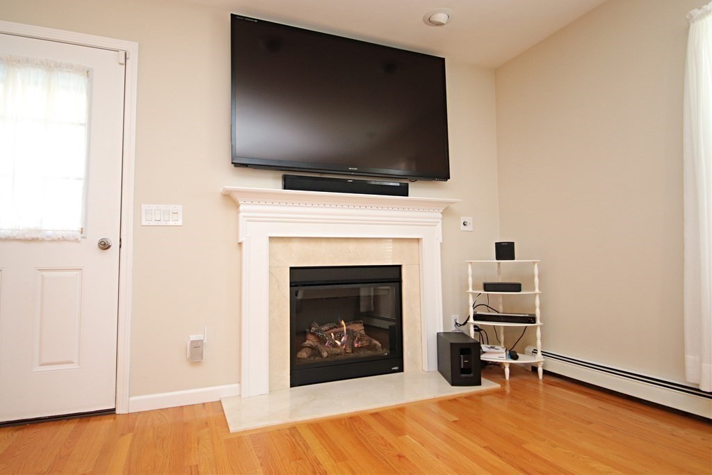 10 Pace Road Saugus, MA 01906 - Photo 14 of 42 a living room with a fireplace and a flat screen tv